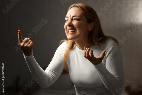 Angry mature woman in bedro...