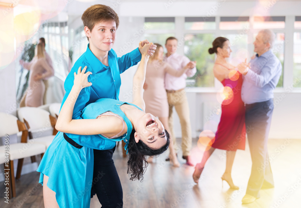 Fototapeta premium Young couple rehearsing and dancing in dance class