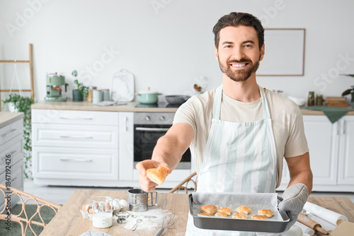 Young man with tasty cookie...