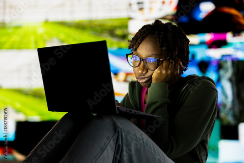 Tableau sur toile Person with tired eyes staring at laptop screen, concept of technology overuse and digital dependence