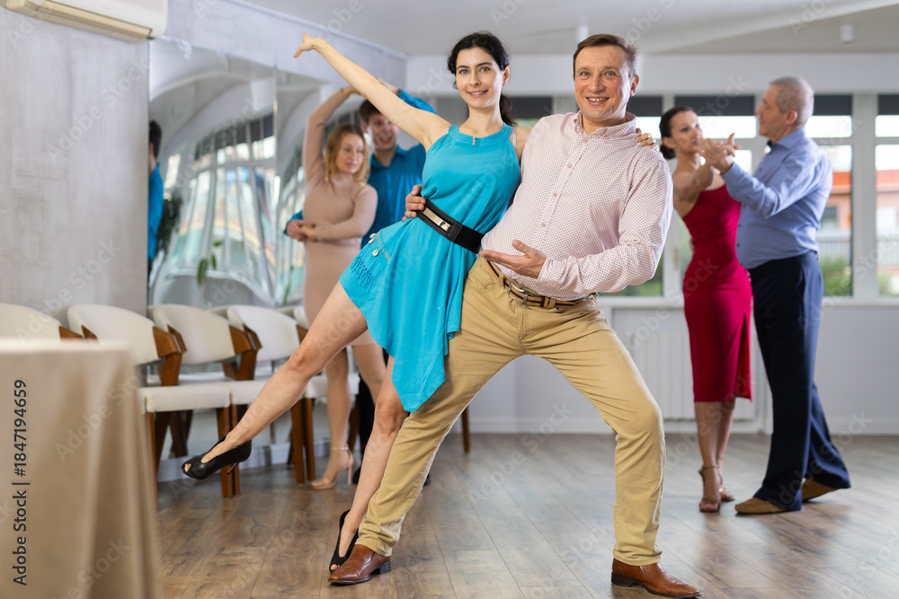 Fototapeta premium Adult man and young woman dancing in dance class