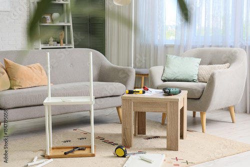 Disassembled shelf unit with tools in living room