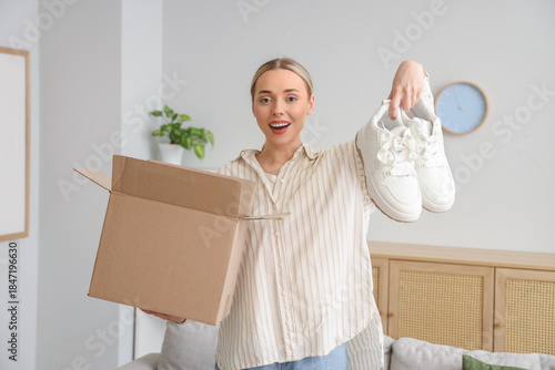 Young woman with parcel box...