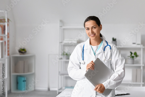 Young female doctor with la...