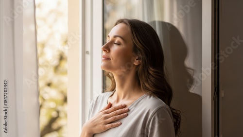 Free Download Woman Standing by Window Taking Deep Breath for Relaxation - GFXLoad