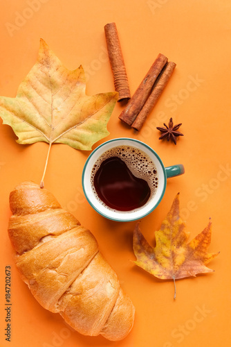 Cup of hot coffee with croi...