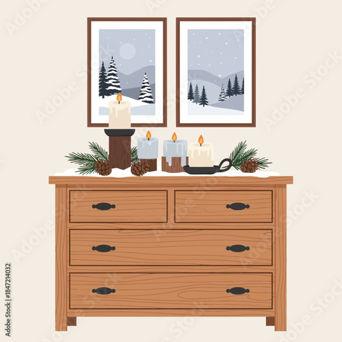 Cozy winter holiday scene with candles and pine branches on wooden dresser
