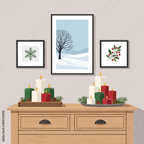 Festive holiday decoration with candles and framed winter landscape art on a wooden sideboard