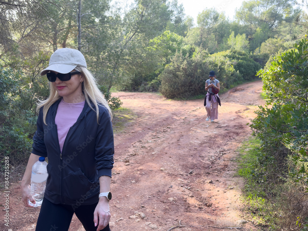 Fototapeta premium Young mother and daughter hiking