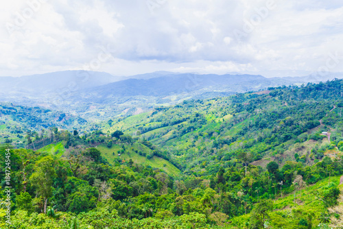 Agricultural landscape with greenhouses and distant rainstorm