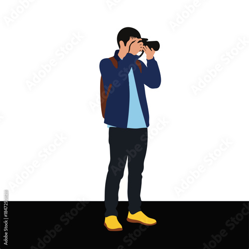 Young man taking photos with camera while standing indoors  