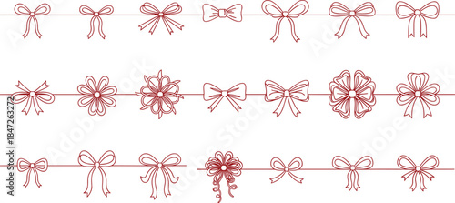 Red bows and snowflakes decorating a string against a white background