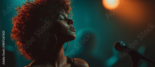 Gorgeous girl with wavy afro hair who sings.  On stage, a beautiful woman sings a karaoke song while using a microphone, spotlights, and smoke