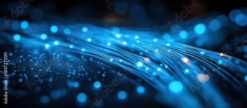 Abstract blue fiber optic lights, dark background, technology
