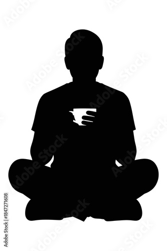 Silhouette of person sitting cross legged meditating or practicing yoga calmly