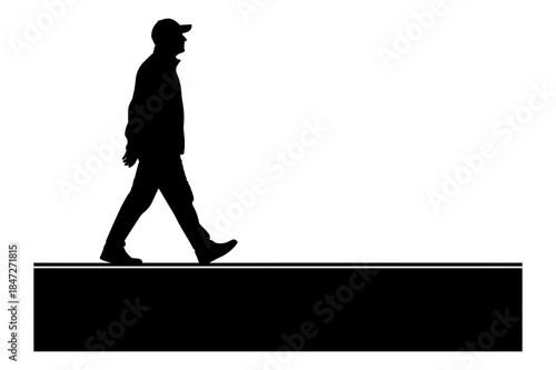 Silhouette of a man wearing a cap walking on a raised platform or curb