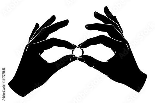Silhouette of hands delicately holding a small ring between two fingers for viewing