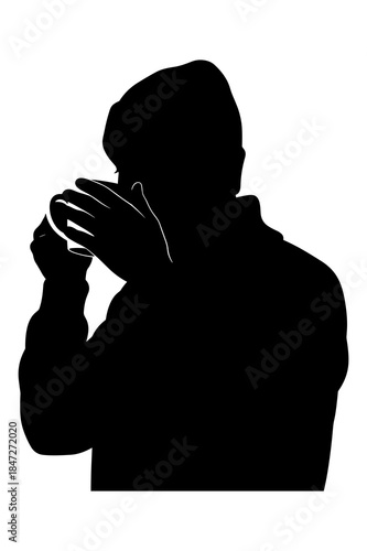 Silhouette of a person playing a small musical instrument like a harmonica or mouth organ