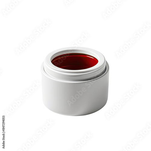 Small cylindrical container, white exterior, red liquid contents, black background
