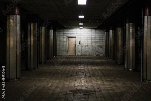 Wallpaper Mural Echoes of Silence: A Dimly Lit Industrial Underground Corridor Torontodigital.ca