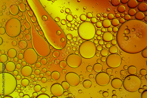 Close up of oil drops on water surface. Colorful abstract macro background of oil drops on water surface with air bubbles inside. Colorful background for gadget and computer wallpaper