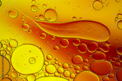 Close up of oil drops on water surface. Colorful abstract macro background of oil drops on water surface with air bubbles inside. Colorful background for gadget and computer wallpaper