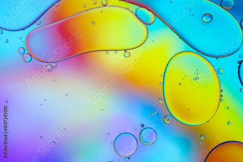 Close up of oil drops on water surface. Colorful abstract macro background of oil drops on water surface with air bubbles inside. Colorful background for gadget and computer wallpaper
