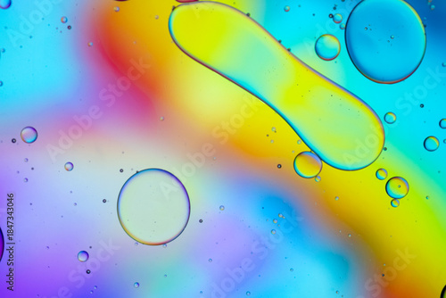 Close up of oil drops on water surface. Colorful abstract macro background of oil drops on water surface with air bubbles inside. Colorful background for gadget and computer wallpaper
