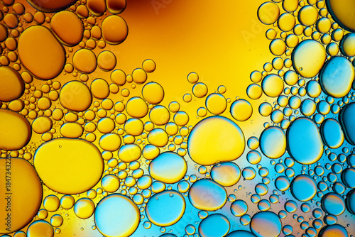Close up of oil drops on water surface. Colorful abstract macro background of oil drops on water surface with air bubbles inside. Colorful background for gadget and computer wallpaper