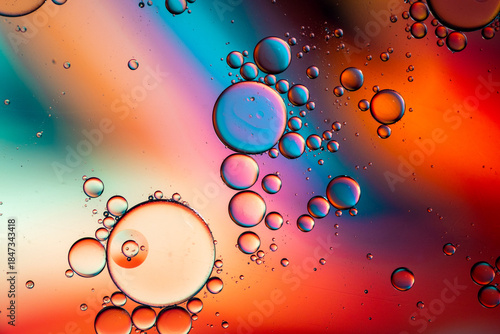 Close up of oil drops on water surface. Colorful abstract macro background of oil drops on water surface with air bubbles inside. Colorful background for gadget and computer wallpaper