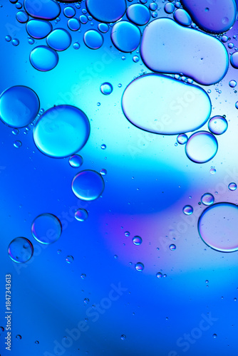 Close up of oil drops on water surface. Colorful abstract macro background of oil drops on water surface with air bubbles inside. Colorful background for gadget and computer wallpaper