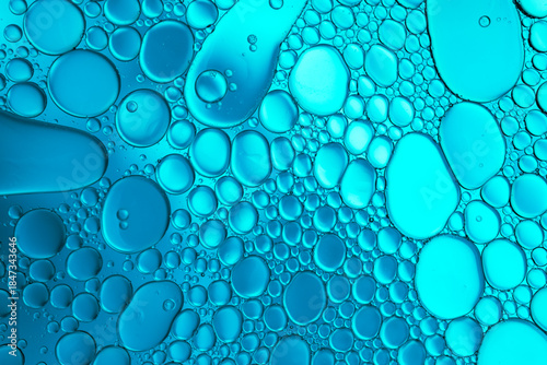 Close up of oil drops on water surface. Colorful abstract macro background of oil drops on water surface with air bubbles inside. Colorful background for gadget and computer wallpaper
