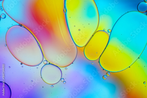 Close up of oil drops on water surface. Colorful abstract macro background of oil drops on water surface with air bubbles inside. Colorful background for gadget and computer wallpaper