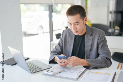 Asian Business man working with laptop. Young business man thinking Concentrated at work.