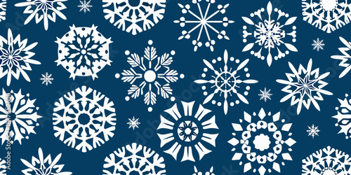 A seamless pattern of delicate white snowflakes on a deep navy background