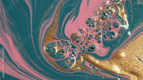 Viscous blend of pink, teal, and gold paint swirling together