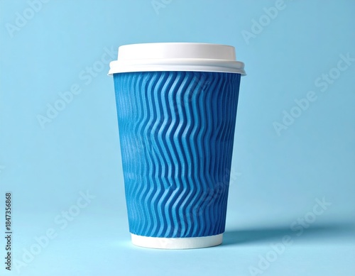 A blue, textured paper cup with a white lid, on a light blue background