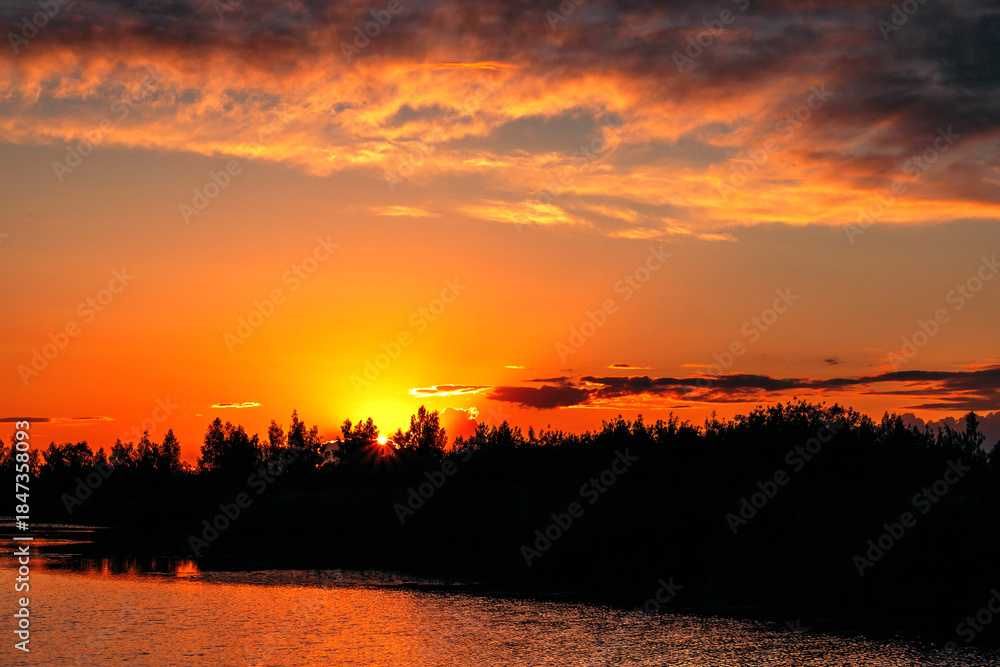 Obraz premium Beautiful summer sunset and colorful sky over the lake. Clouds are reflected in the calm water. Beauty in this world