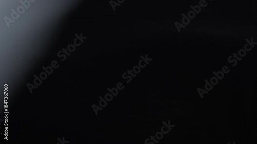 Wispy, ethereal smoke-like swirls against a dark, abstract background, creating a mesmerizing texture