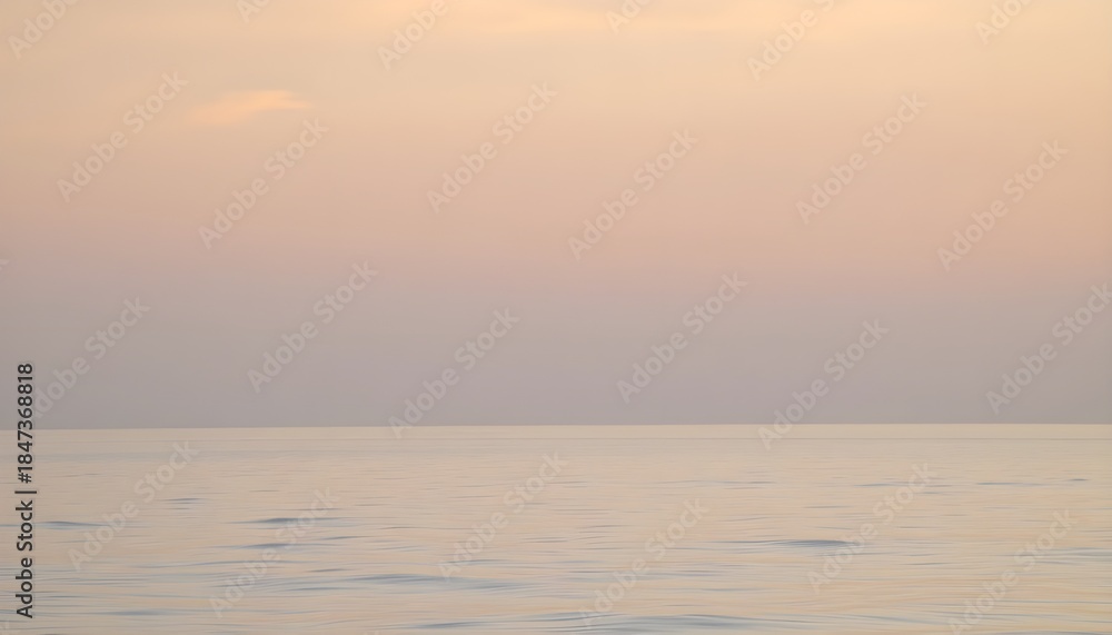 Fototapeta premium Minimalist seascape with calm water and pastel sunset sky near the horizon. Great for travel, relaxation, meditation themes, backgrounds, and typography overlays.