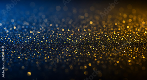Golden glittering particles on dark blue background