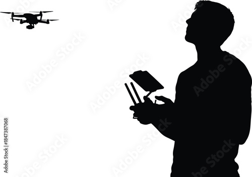 Silhouette of a drone pilot controlling a quadcopter with a remote controller