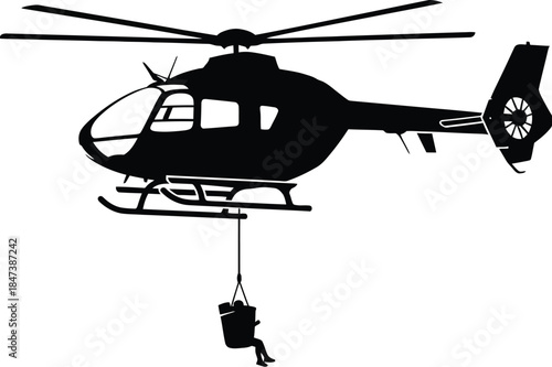Silhouette of a rescue helicopter hoisting a person in a sling