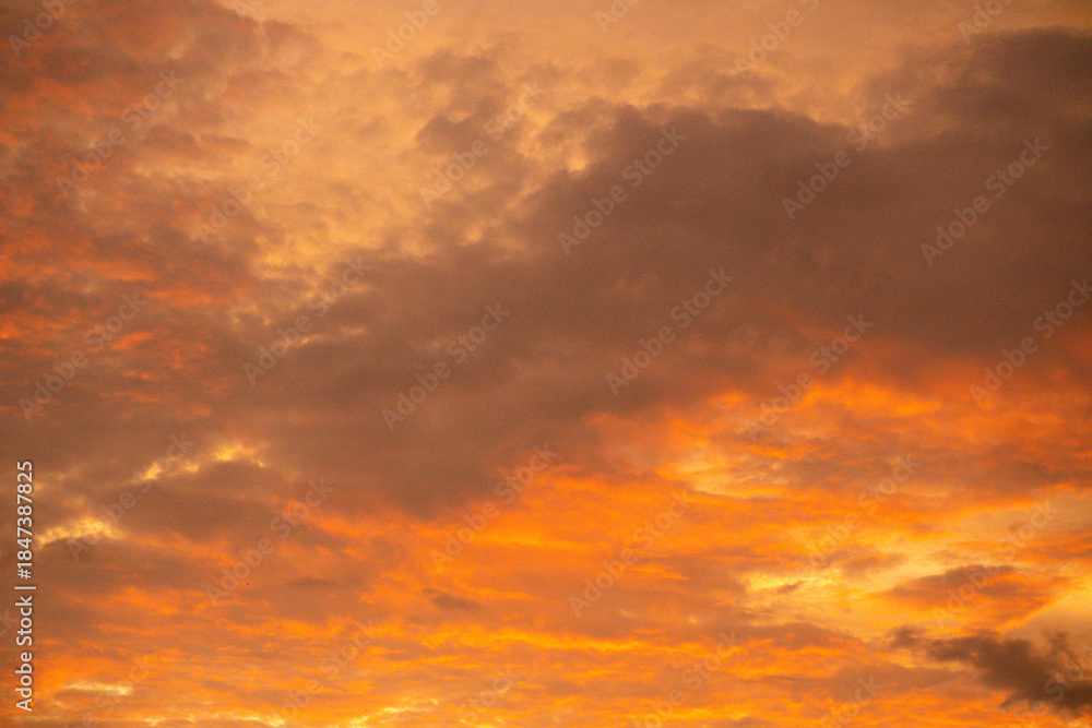 Fototapeta premium Dramatic twilight sky, the beauty of slightly overcast orange clouds.