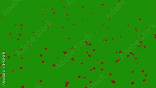 Red hearts falling on green background