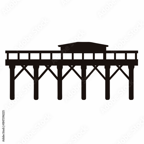 Silhouette of a wooden pier structure extending out to sea or lake