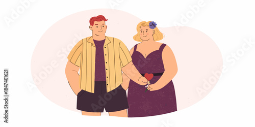 A loving couple stands closely together holding a small red heart
