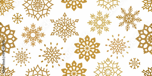Golden snowflakes scattered across a white background creating a winter pattern