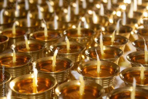 Buddhist Altar Candles at Religious 108 Butter Lamp Festival in Temple Monastery. Pouring Melted Butter Oil. Preparation process