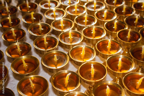 Buddhist Altar Candles at Religious 108 Butter Lamp Festival in Temple Monastery. Pouring Melted Butter Oil. Preparation process